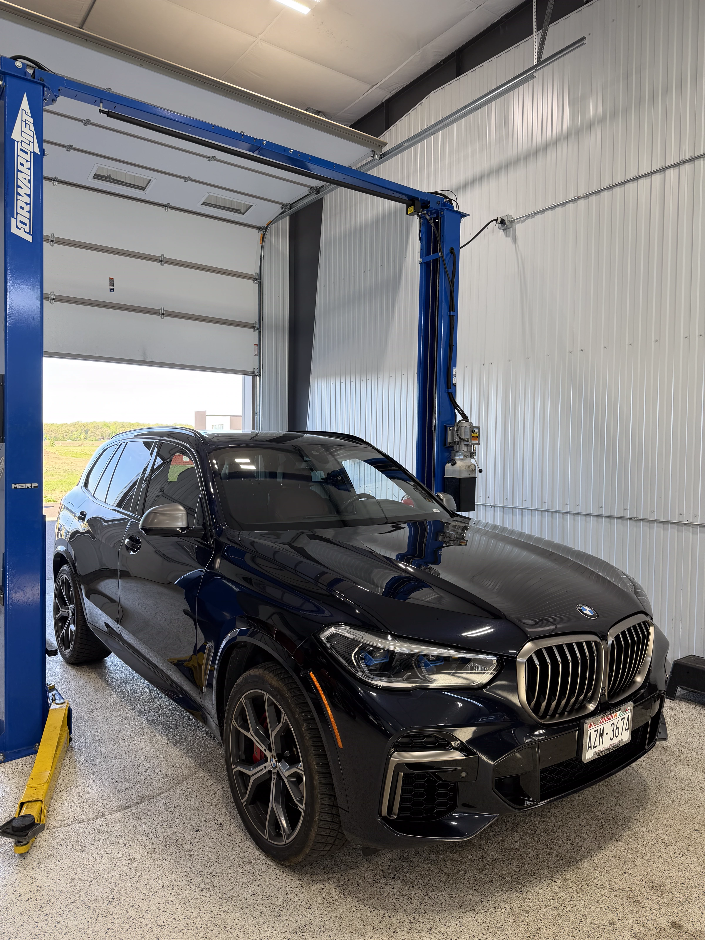 Black BMW X5 M in the bay at The Upgrade Shop, Unit 123